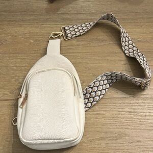 Ah-dorned cream cross body bag.